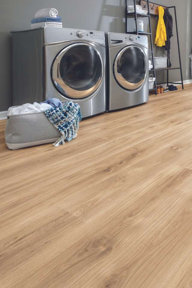 white oak look laminate flooring in modern laundry room with grey walls